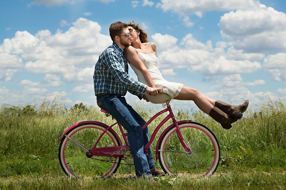 Happy Couples On Bicycle