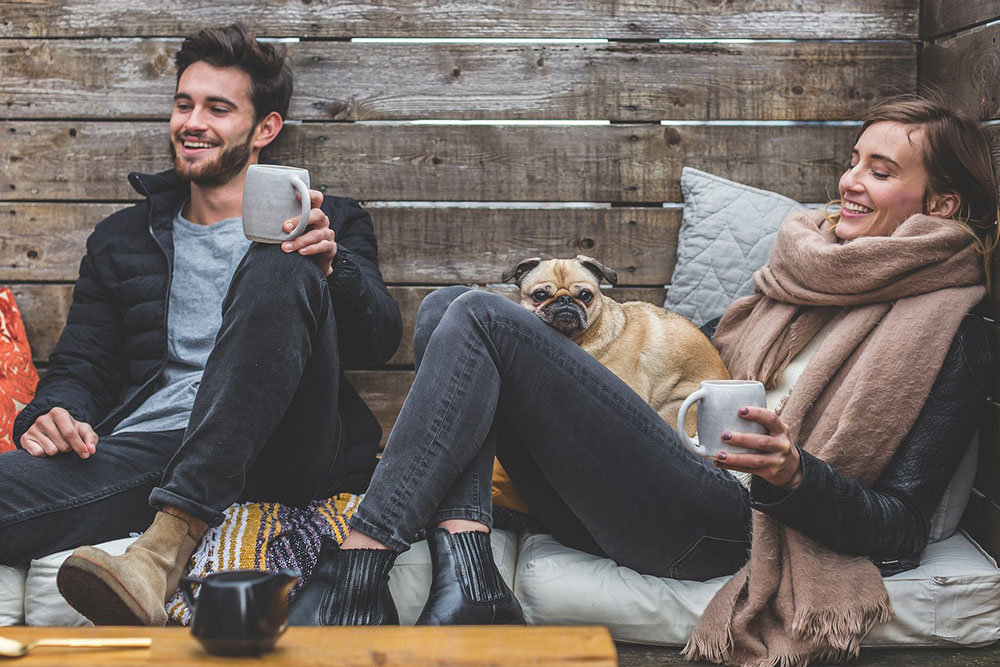 Man And Woman Relaxing With Dog