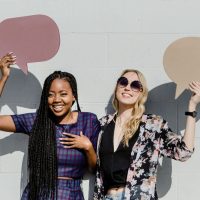 Women Holding Speech Bubbles